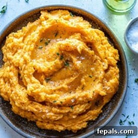 Velvety Sweet Potato Mash 11 mashed sweet potato in a brown rustic bowl