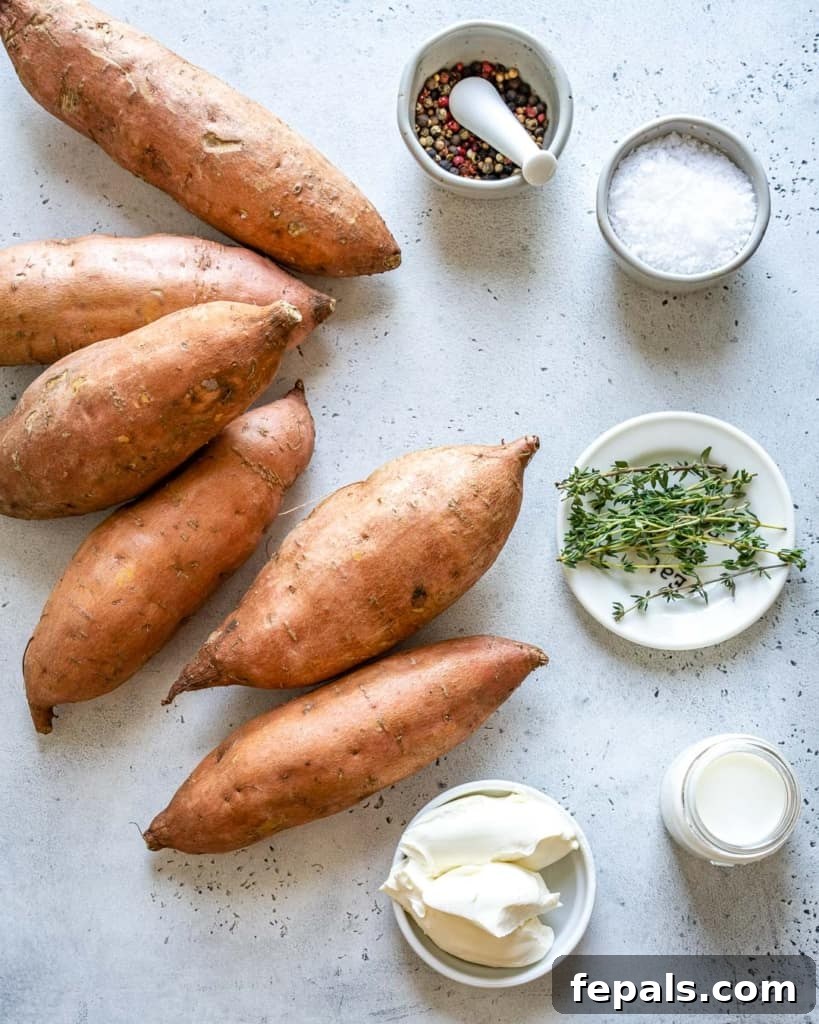 Velvety Sweet Potato Mash 4 A vibrant selection of fresh ingredients laid out on a kitchen counter, including bright orange sweet potatoes, a block of cream cheese, fresh thyme, and a bottle of milk, all ready for making mashed sweet potatoes.