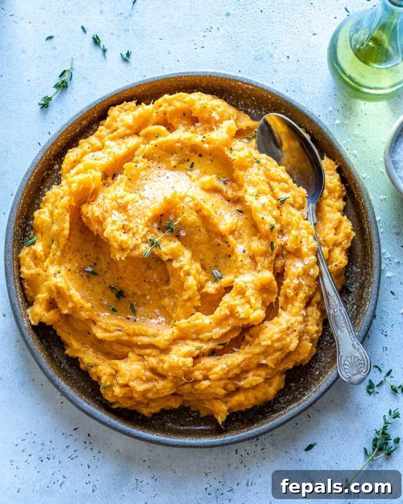 Velvety Sweet Potato Mash 9 A top-down view of a beautifully prepared sweet potato dish in a stylish gray bowl, highlighting its appealing presentation.