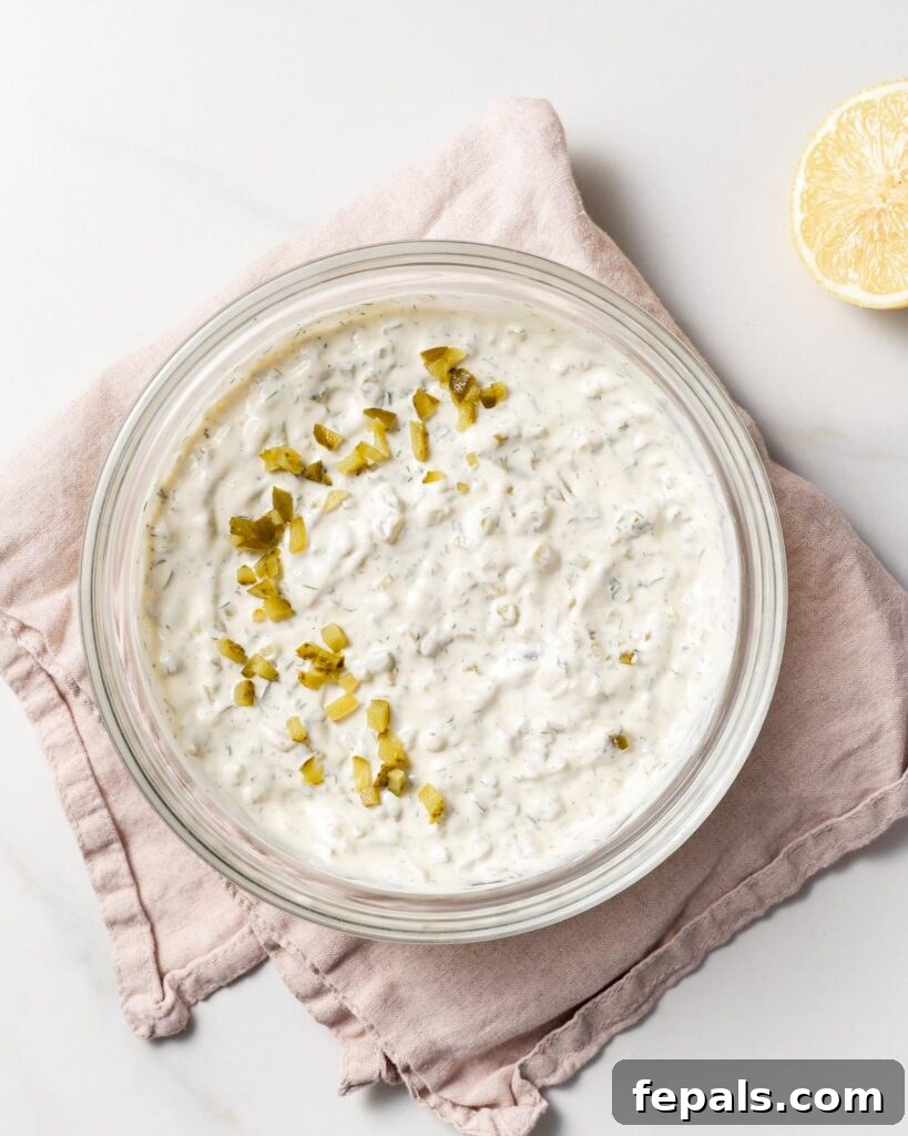 top view of tartar sauce in a bowl with pickle relish garnish