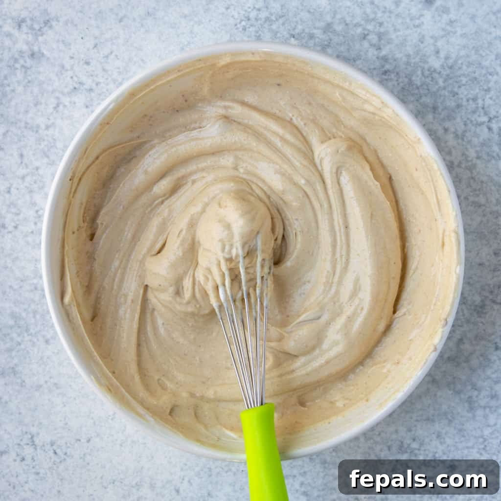 Peanut Butter Bliss Dip 11 yogurt dip ingredients being mixed with whisk