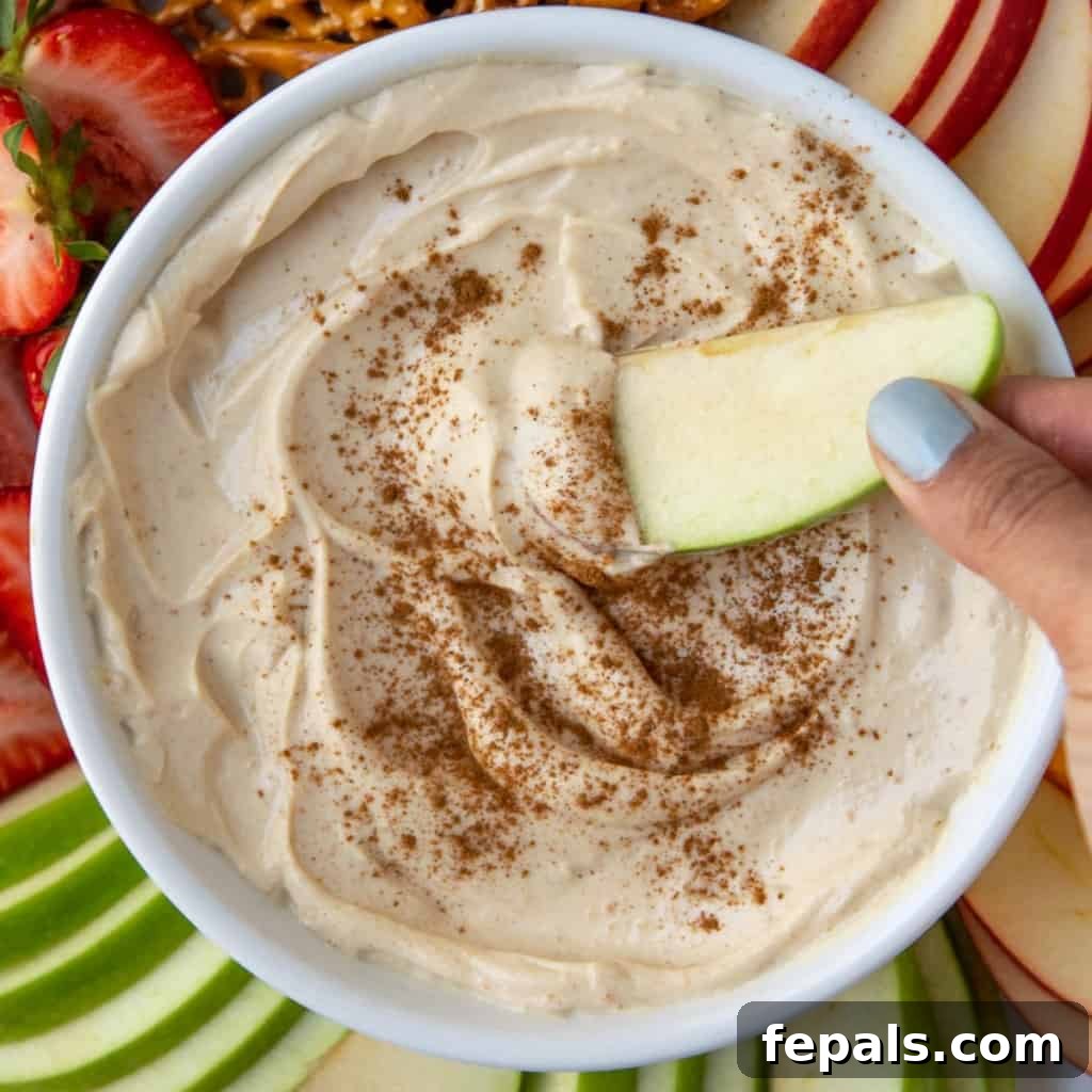 Peanut Butter Bliss Dip 14 close up fruits bowl with hand holding apple in dip