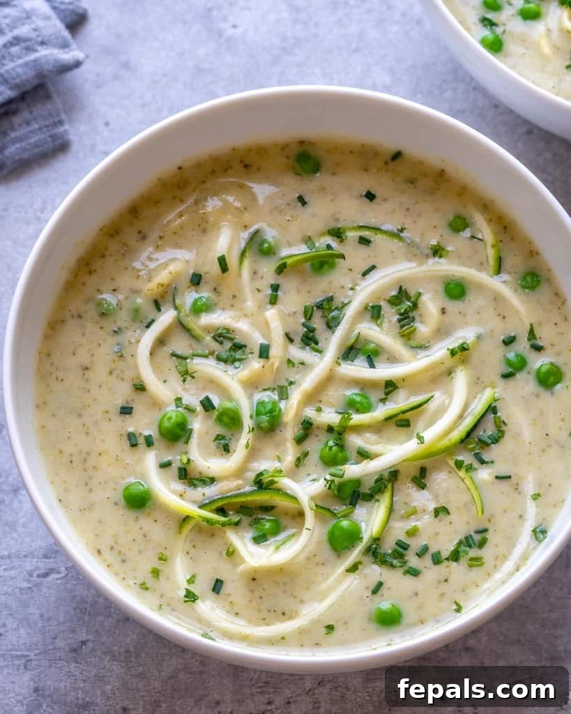 top view zucchini noodle and broccoli soup in a white bowl
