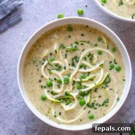 creamy looking broccoli zucchini soup in a round bowl.