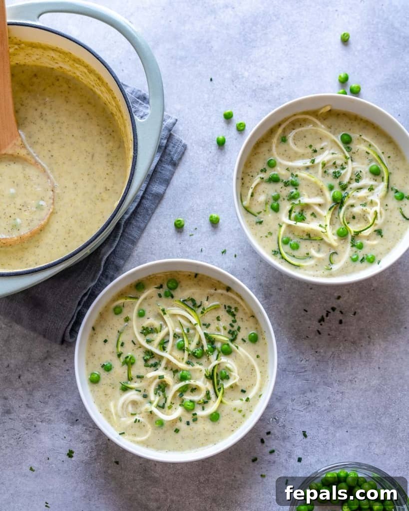 two bowls of zucchini broccoli soup next to pot of soup