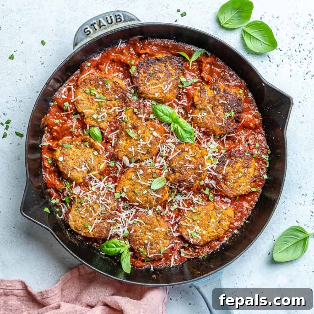 Savory Garden Meatballs 2 Sizzling Vegetarian Meatballs in a black skillet, perfectly browned and ready for sauce.