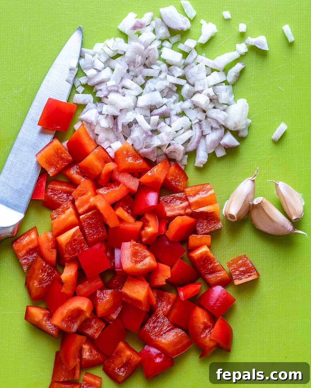 Creamy Coconut Shrimp Curry 5 Chopped shallots and sliced red bell pepper neatly arranged on a cutting board, ready for cooking