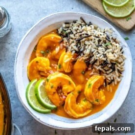 Creamy Coconut Shrimp Curry 10 Top view of shrimp curry with wild rice in a white bowl, ready to serve