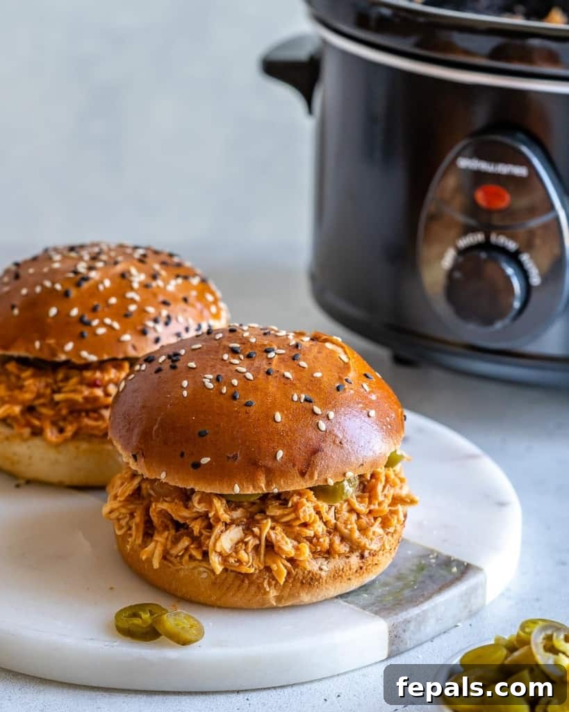 Two chicken burgers on white surface