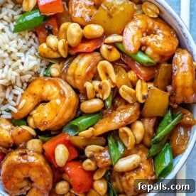 Top view of kung pao shrimp in white bowl