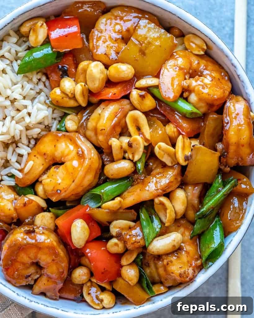 Spicy Szechuan Peanut Shrimp 3 Close-up top view of vibrant Kung Pao shrimp in a white bowl, showcasing bell peppers and green onions