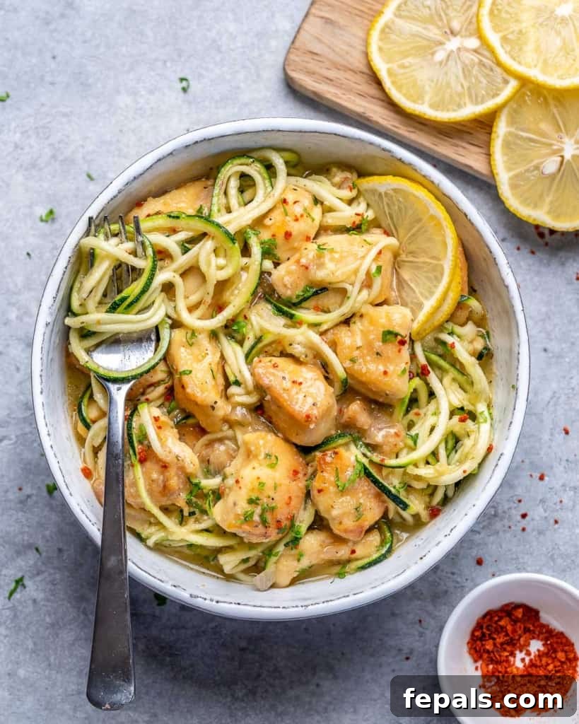 top view chicken scampi n a bowl with fork in bowl.