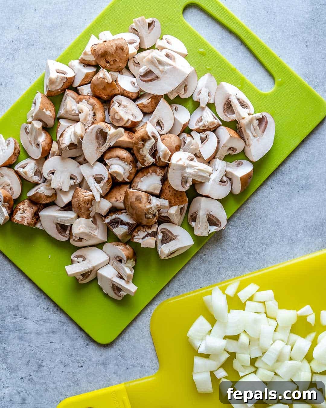Heartwarming Beef Stroganoff Soup 5 Chopped mushrooms and onions on cutting board for soup