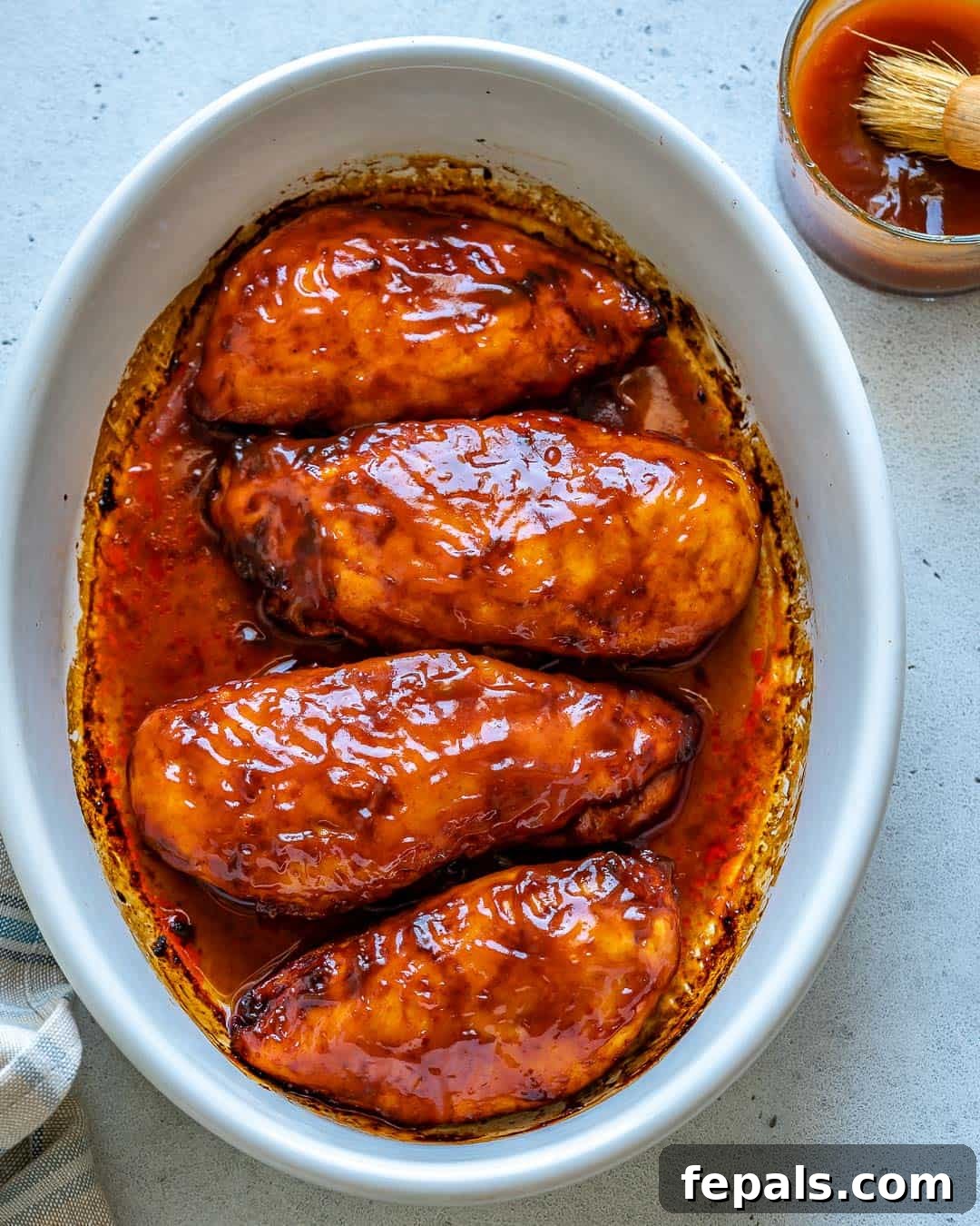 Glazed BBQ Chicken Breast 9 top view of 4 baked chicken breast in a white dish
