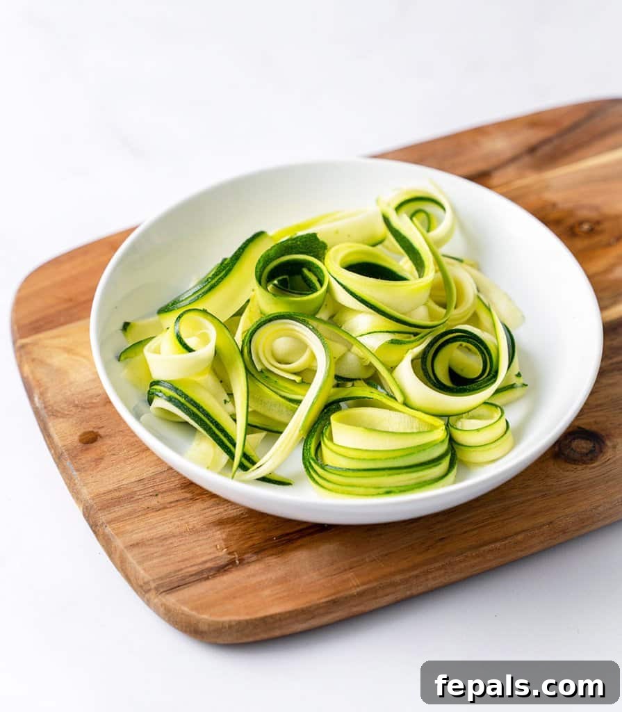 Simple Steps to Homemade Zucchini Noodles 11 a generous serving of zoodles on a pristine white plate, ready for consumption