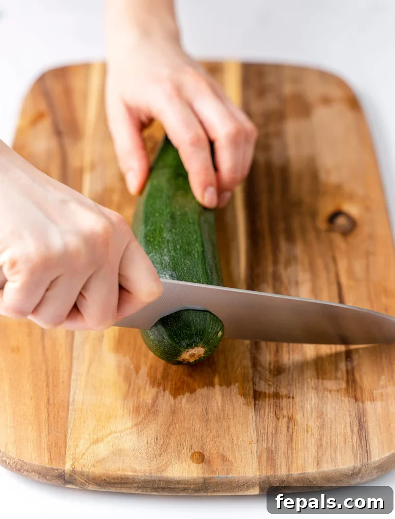 Simple Steps to Homemade Zucchini Noodles 12 fresh zucchini being prepared on a cutting board