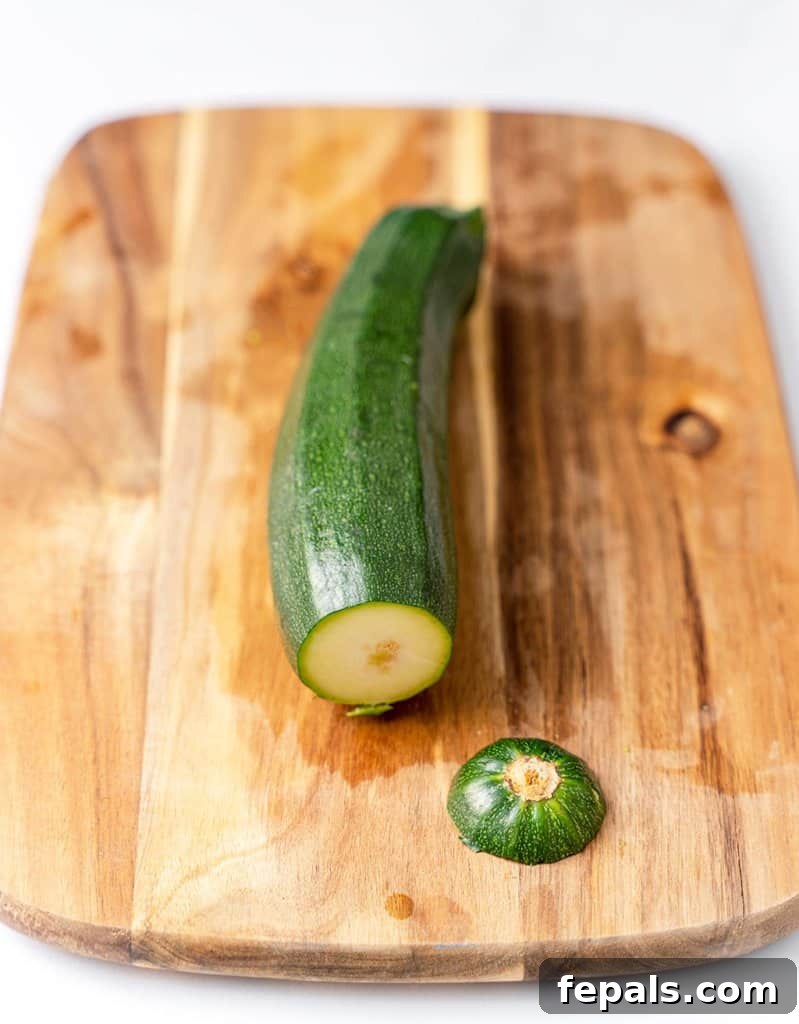 Simple Steps to Homemade Zucchini Noodles 7 tip of zucchini cut off on a cutting board, ready for preparation