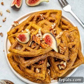 Top view of fluffy homemade pumpkin waffles topped with fresh figs.