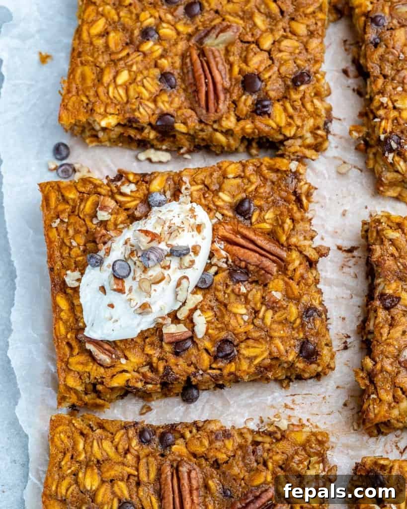 Spiced Pumpkin Chocolate Chip Breakfast Bake 3 pumpkin baked oatmeal squares on a parchment paper
