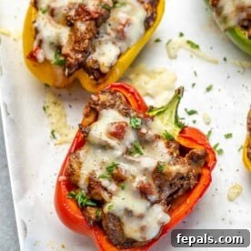 Fiesta Keto Steak Stuffed Peppers 12 Side view of stuffed peppers on a plate.