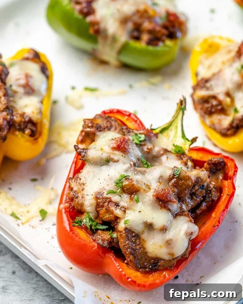 Fiesta Keto Steak Stuffed Peppers 10 Four perfectly cooked keto taco stuffed peppers on a baking sheet, ready to be served.