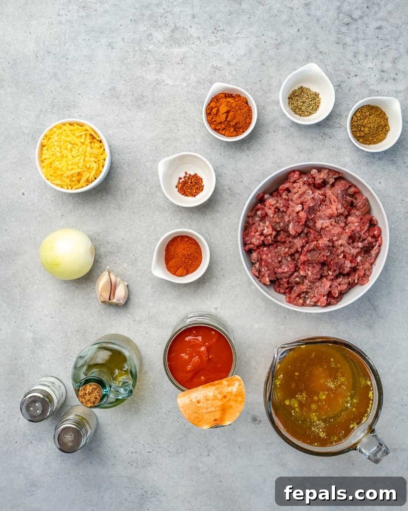 Ultimate Keto Beef Chili 4 Top down view of ingredients for the keto chili recipe laid out on a wooden surface.