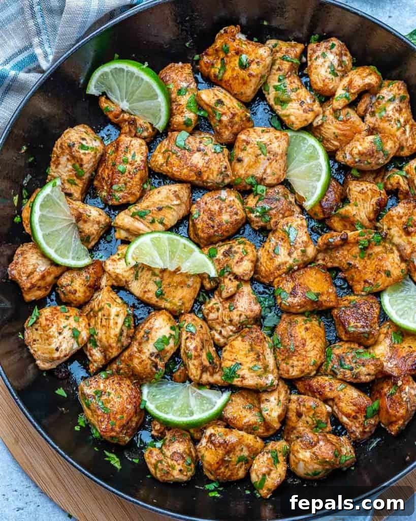 Top view of cooked cilantro lime chicken bites in a black skillet, ready to be served