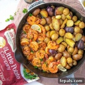 top view shrimp and potatoes in black skillet