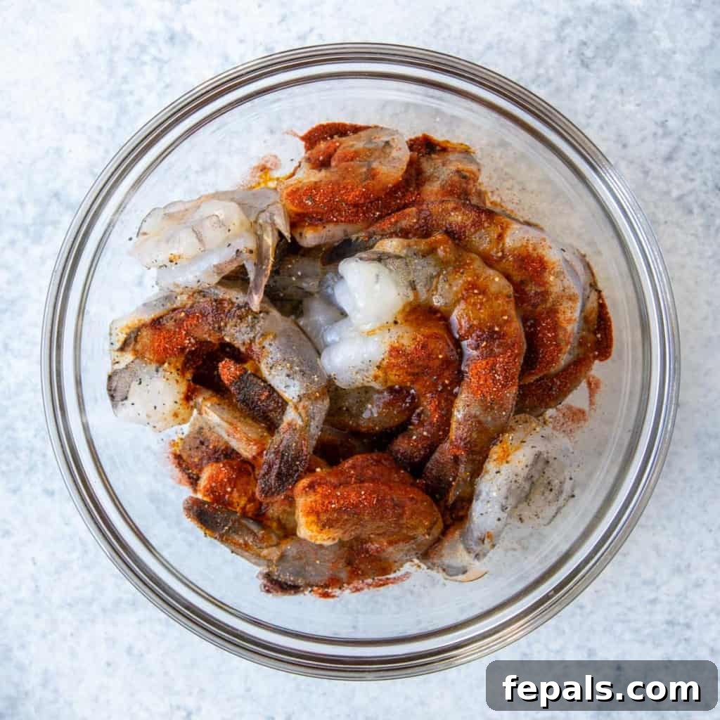 Golden Honey Mustard Shrimp and Crispy Potatoes 7 raw shrimp in bowl with spices on it