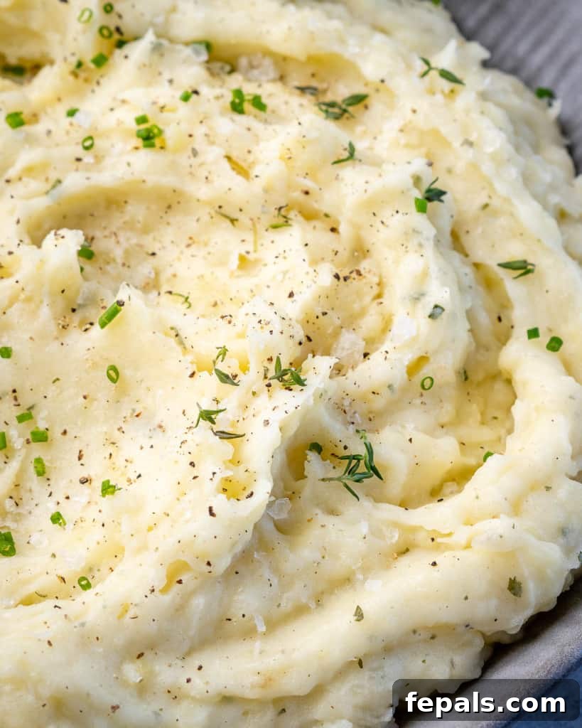 Creamy potato mash in a grey bowl, simple and elegant.