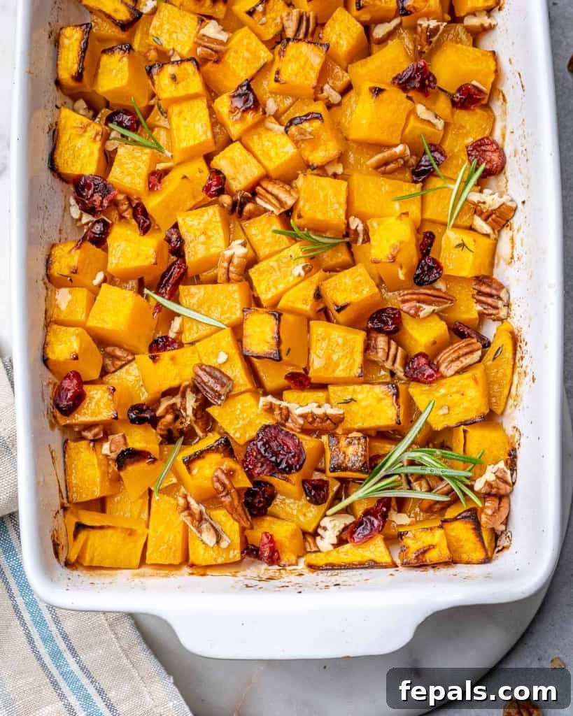 Maple Caramelized Butternut 3 Close-up top view of roasted butternut squash cubes in a white baking dish before garnishing.