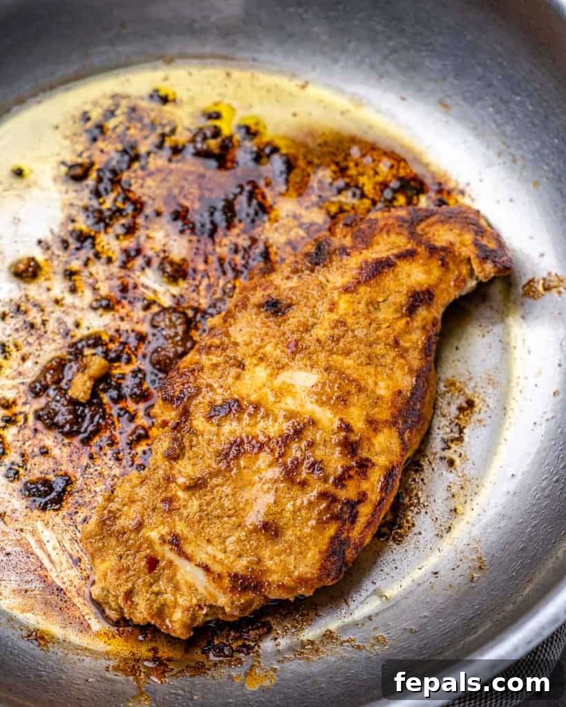 Flavorful Tandoori Chicken Made Easy 6 Tandoori chicken cooking in stainless steel skillet