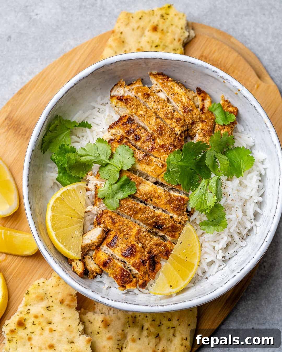 Flavorful Tandoori Chicken Made Easy 7 Overhead of bowl of rice with sliced tandoori chicken.