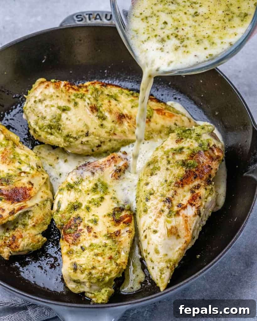 Irresistible Pesto Chicken 4 pesto milk sauce being pour over the chicken breast
