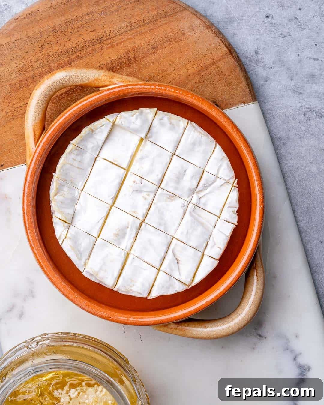 Warm Brie with Jewels of Pomegranate 5 Brie cheese in baking dish before baking