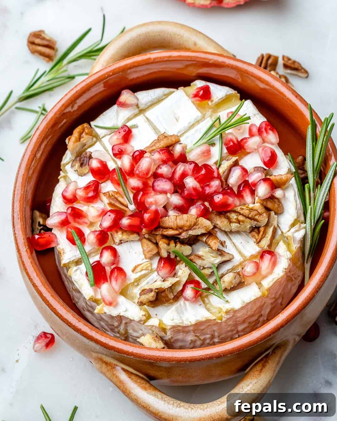 Warm Brie with Jewels of Pomegranate 7 Baked brie with pomegranates, pecans, rosemary, and honey toppings