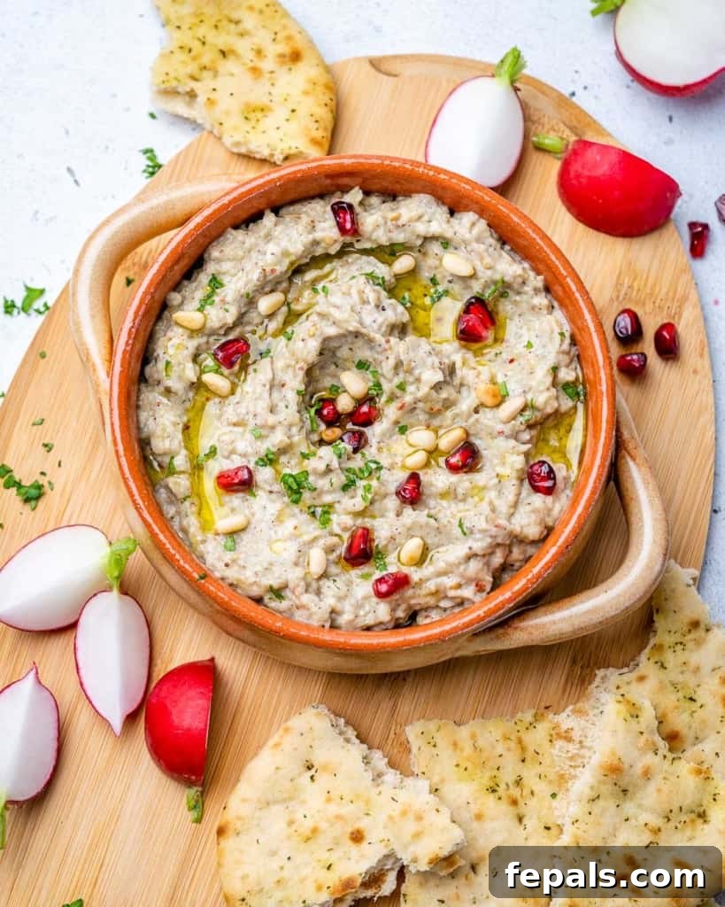 Smoky Eggplant Dip Perfection 7 top view baba ganoush dip on a board with side of pita bread