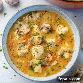 top view chicken soup in white rustic bowl