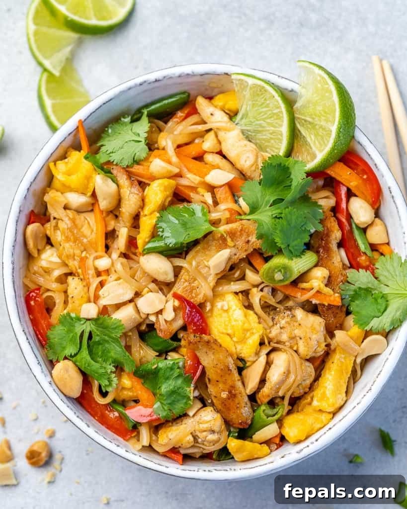 Signature Chicken Pad Thai 2 Vibrant and savory Chicken Pad Thai served in a white bowl, viewed from above, garnished with fresh cilantro and crushed peanuts.