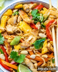 Signature Chicken Pad Thai 10 A close-up shot of a comforting bowl of chicken pad thai, showcasing the rich flavors and textures, ready to be served.
