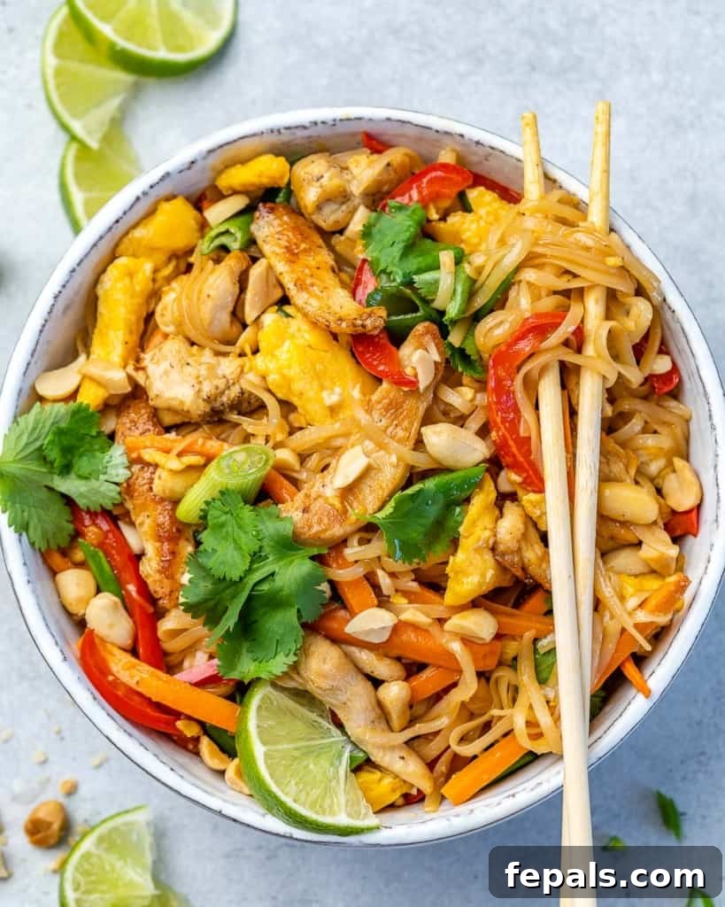 Signature Chicken Pad Thai 4 A beautifully plated bowl of Chicken Pad Thai, featuring tender chicken, fresh vegetables, and rice noodles, with chopsticks resting on the side, ready to be enjoyed.