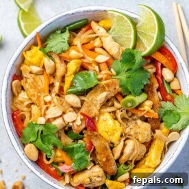 top view of chicken pad thai in white bowl