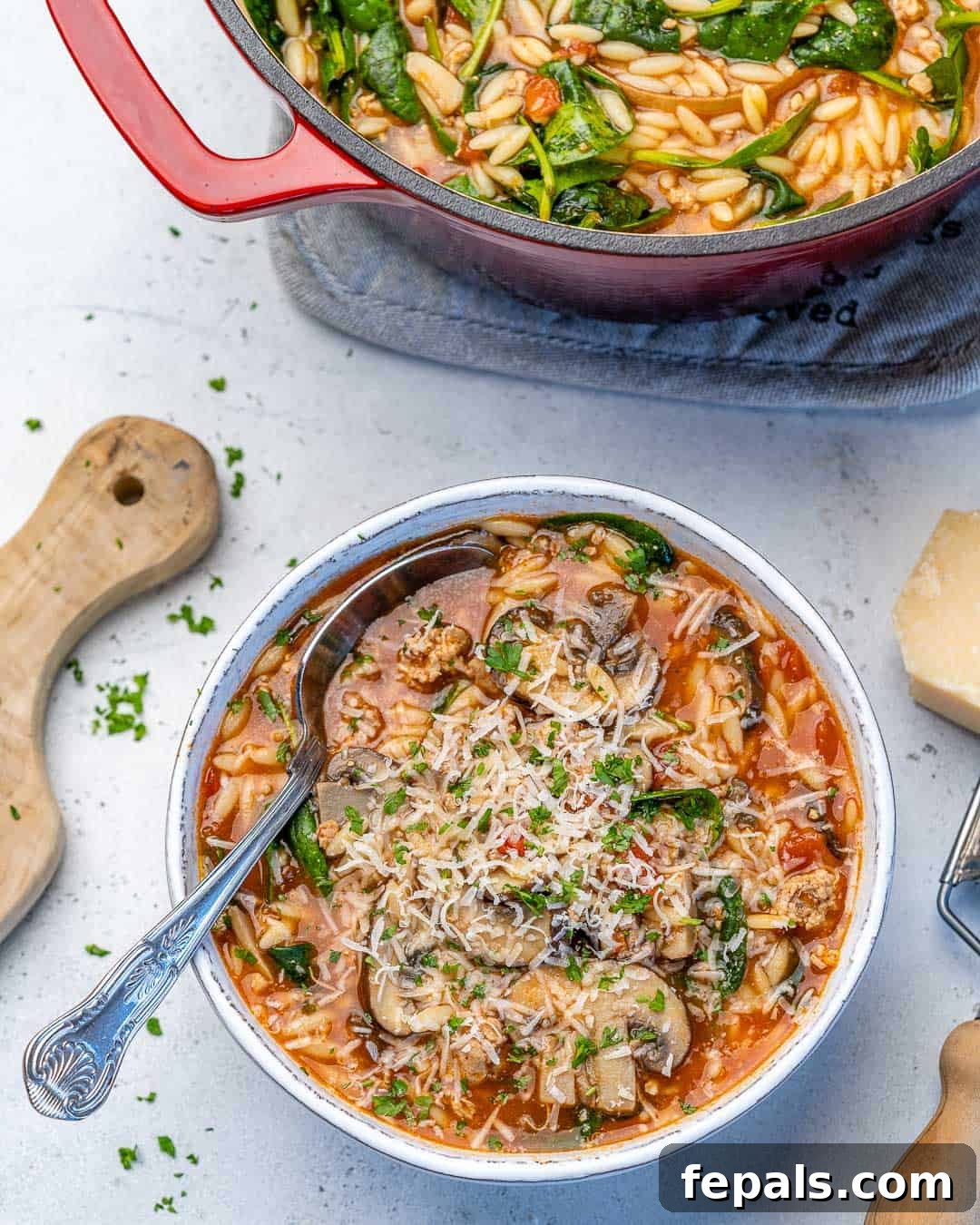 Comforting Lemon Chicken Orzo Soup A comforting bowl of Lemon Chicken Orzo Soup with fresh spinach and grated Parmesan, ready to be enjoyed.