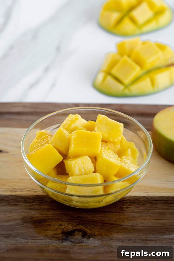 Diced fresh mango in a glass bowl, showcasing its vibrant color and readiness for consumption