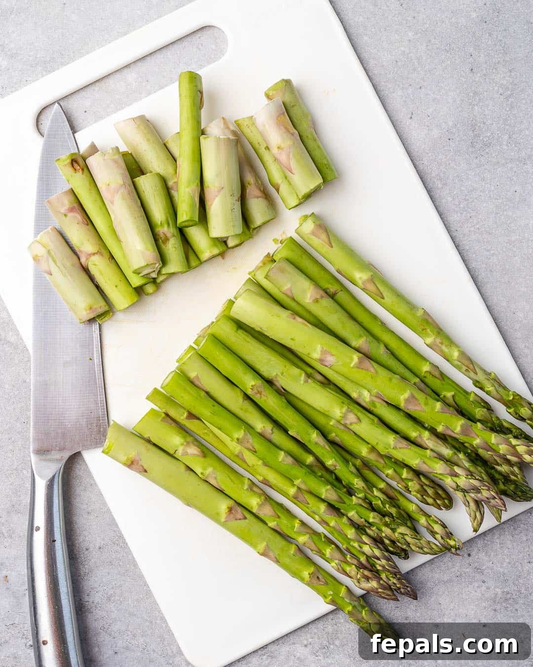 Parmesan Crusted Asparagus 5 asparagus on white platter with ends trimmed out