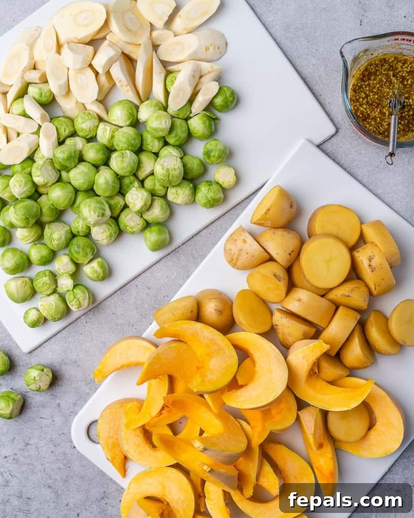 Golden Roasted Vegetables 5 Various chopped vegetables, including butternut squash, parsnips, Brussels sprouts, and potatoes, neatly arranged on a wooden cutting board, ready to be seasoned and roasted.