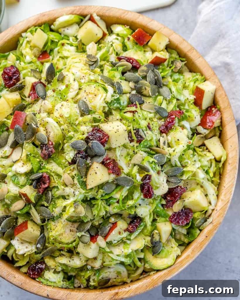 Elevated Shaved Brussels Salad 3 Close-up of shaved Brussels sprouts salad in a bowl, highlighting the texture and freshness.