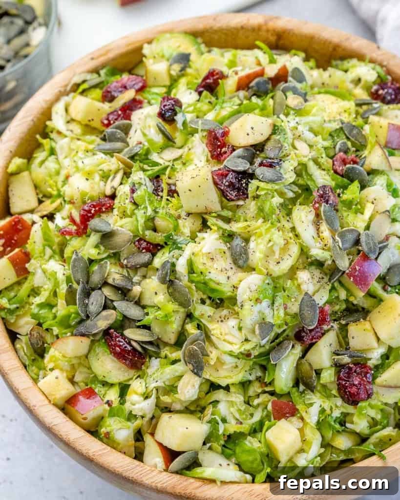 Elevated Shaved Brussels Salad 8 Angled photo showcasing a generous bowl of fresh Brussels sprouts salad ready to be enjoyed.