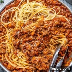Hearty Beef Bolognese 11 tongs in a pasta bolognese pan