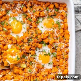 Roasted Sweet Potato Medley 10 sweet potato hash and eggs in a white baking dish.
